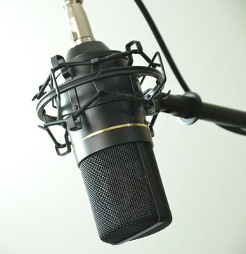 Large-diaphragm condenser microphone suspended from microphone stand